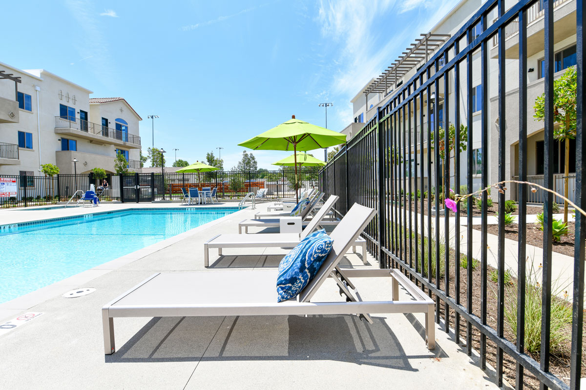 Vista Apartments for Rent - Breeze Hill - Gated Pool with Lounge Seating, Tables, and Umbrellas