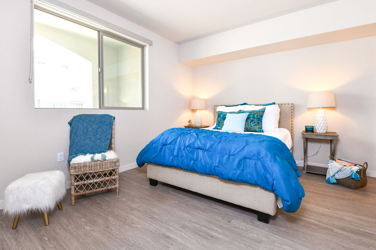 North County San Diego Apartments - Breeze Hill - Bedroom with Hardwood Style Flooring and a Large Window