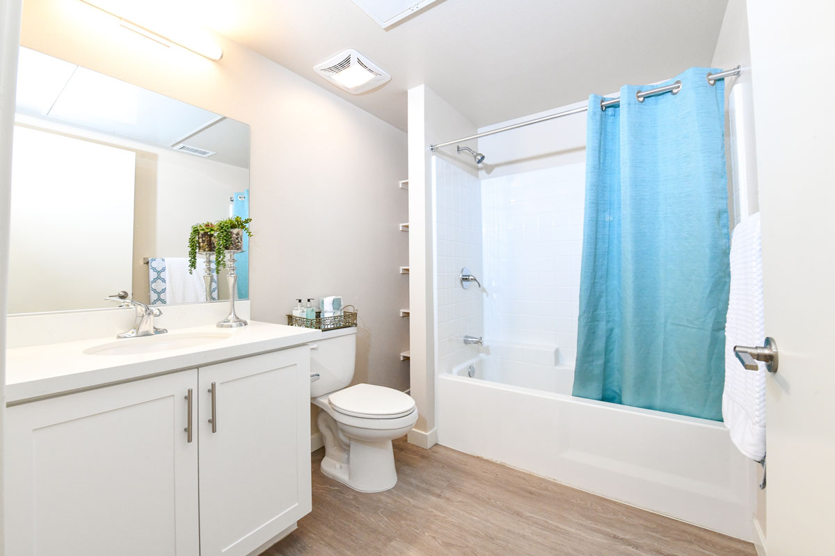 Vista, CA Apartments - Breeze Hill - Spacious Bathroom with White Cabinetry, Large Vanity, White Countertops, and Wood-Style Flooring